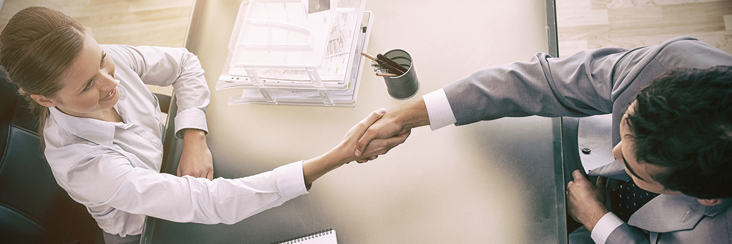 Above view of consultant shaking hands with customer