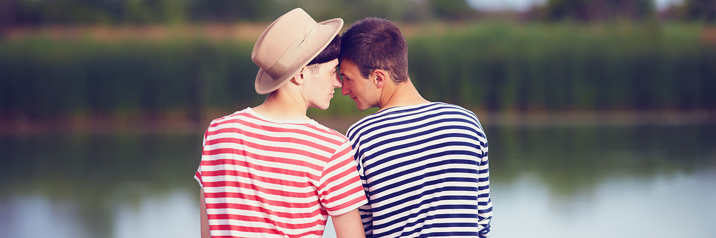 gay couple in love on river bank