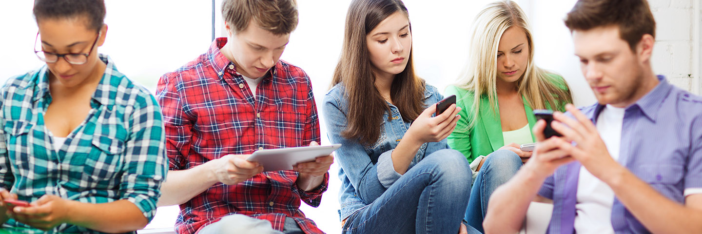 students looking into devices at school
