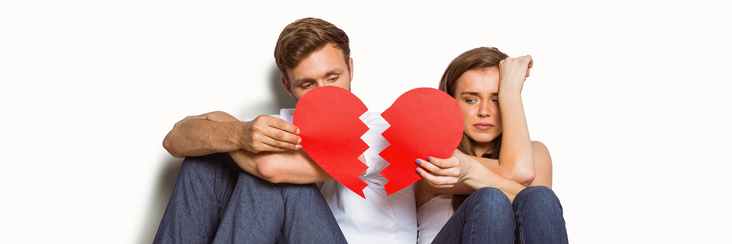 Young couple holding broken heart